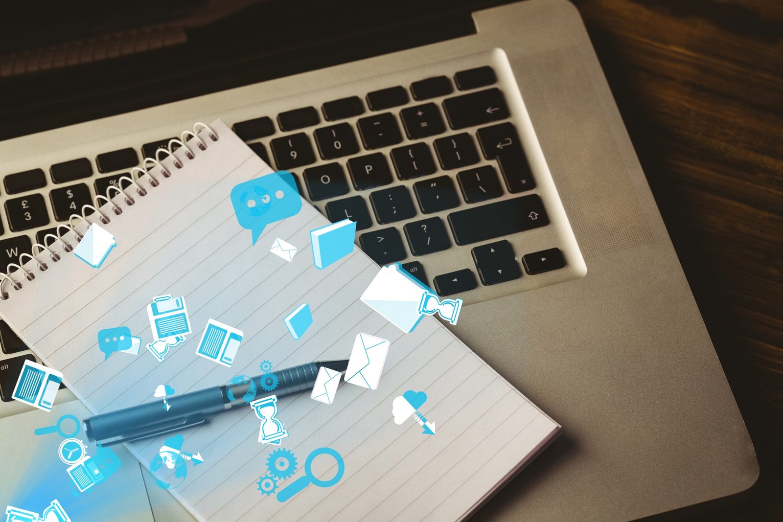 digital composite of note pad on laptop with graphics